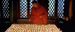 The above picture depicts a monk performing light offerings, which is a common and daily practice of