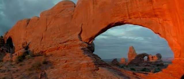 It is Turret Arch in the distance framed by North Window Arch In Arches National Park, Utah It is Turret Arch in the distance framed by North Window Arch In Arches National Park, Utah