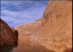 Location: Glen Canyon National Recreation Area (Lake Powell). 

There are countless narrow canyons having still water such as this. Depending on the specific location - as Lake powell is said to have approximately 2,000 miles of shoreline - this formation is either the Cedar Mesa formation of Permian age, or the Navajo Sandstone of Jurassic age. The northern end of Lake powell has a greater exposure of the former, whilst the mid-to-southern end has greater amounts of Navajo Sandstone.