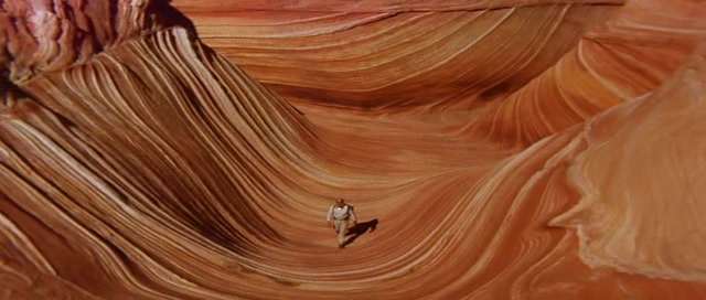 This feature is called "The Wave" and is located at Coyote Buttes North, just South of the Arizona/Utah border in the United States.  20 hikers are allowed here per day - permits are issued via a lottery system.