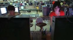 Television assembly line, with inspection stations / technicians in foreground.